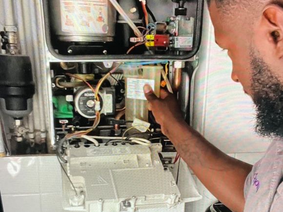 Gas engineer doing a service check on a boiler