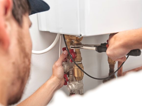 man fixing boiler