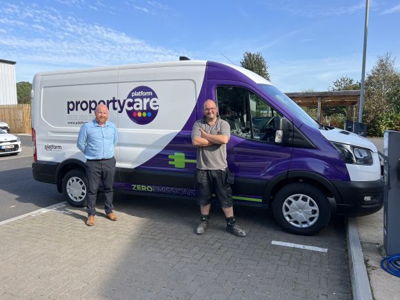 Adam Jones handing over the first electric vehicle to colleague John