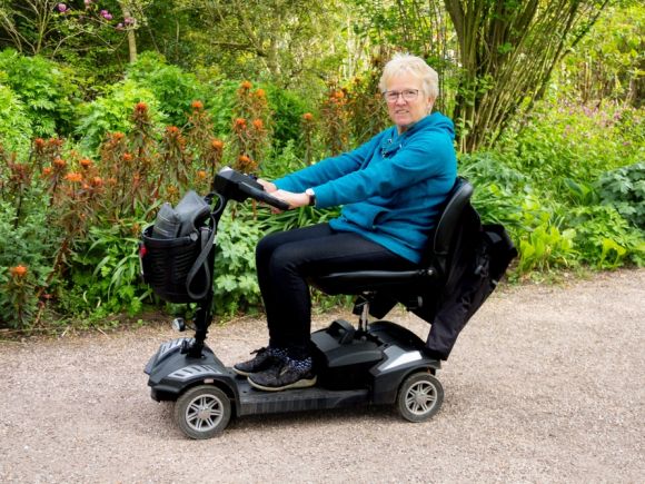 Elderly lady on mobility vehicle
