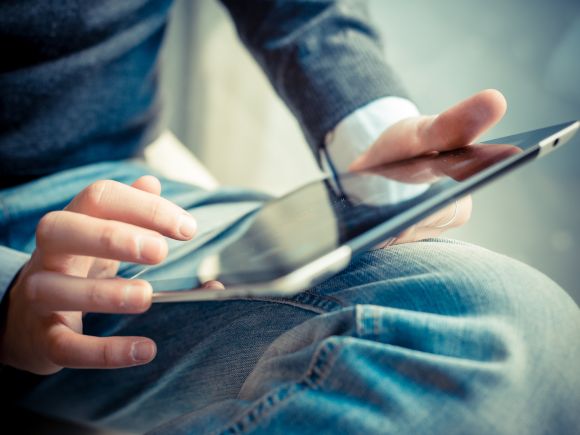 Reading the 10-year repair support for shared ownership homes guide on a tablet