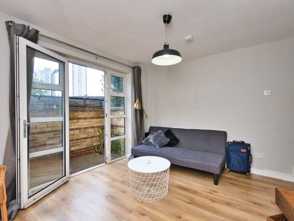 An empty furnished living room with open bifold doors - Ending a tenancy on behalf of someone else