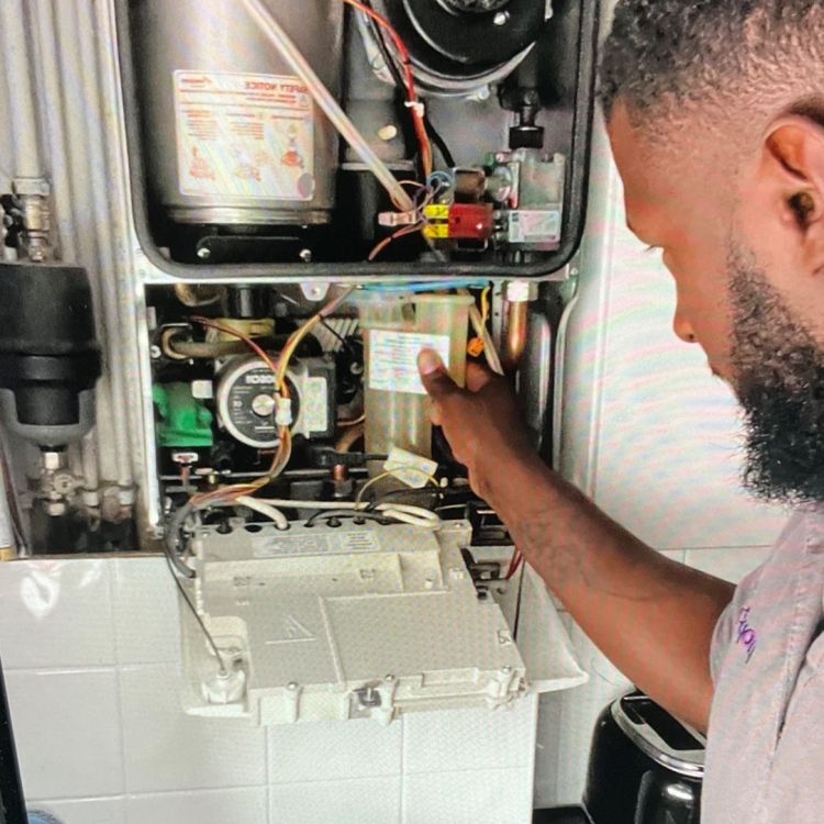 Gas engineer doing a service check on a boiler