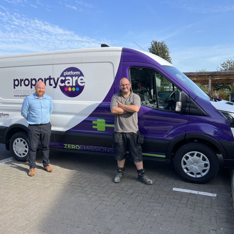 Adam Jones handing over the first electric vehicle to colleague John