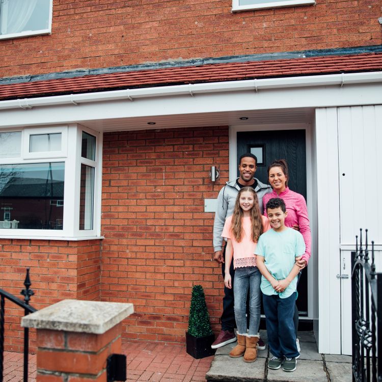 PHG Customer Digital Handbook - Family at the door of their house