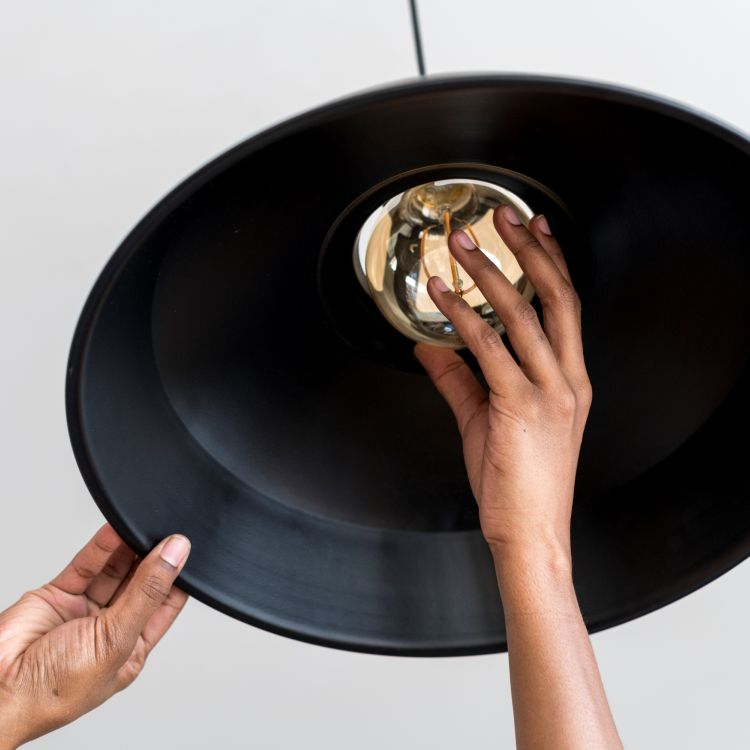 Woman's hands changing a lightbulb