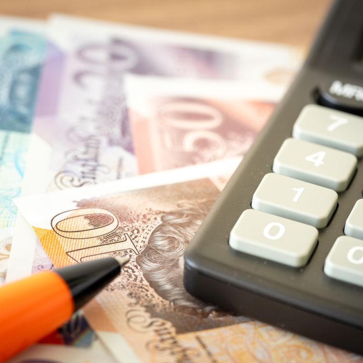 Image of money and a calculator, checking money and benefits