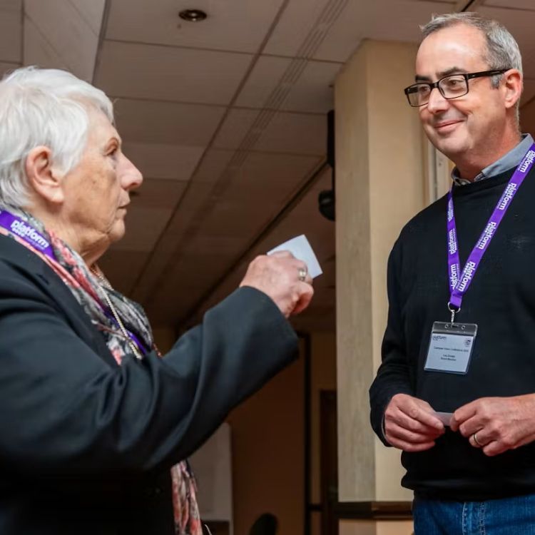 Customers engaged in conversation at the customer conference 2025