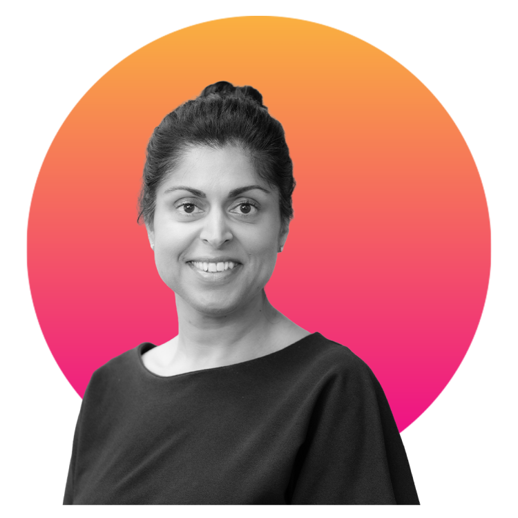 Black and white image of a smiling woman in front of a graduating orange to red circle
