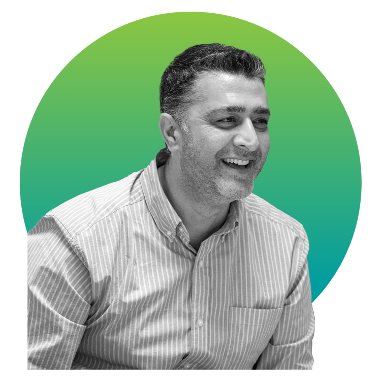 Happy man looking to the right in front of a green gradient circle