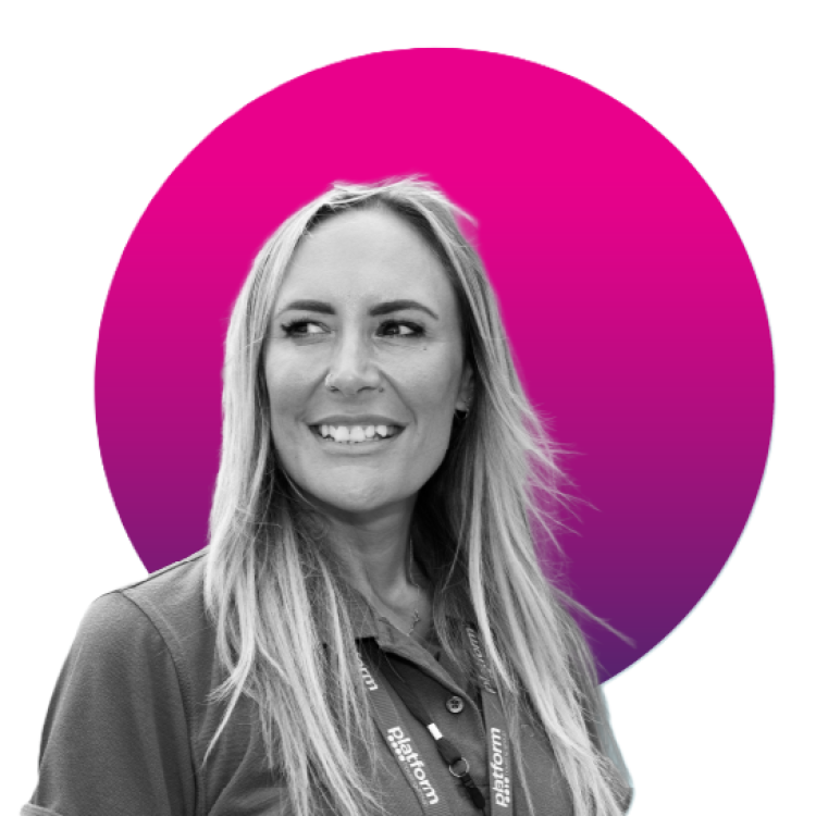 Colleague wearing a Platform lanyard smiles and looks to the side; black-and-white portrait set against a magenta circle on a pale background.