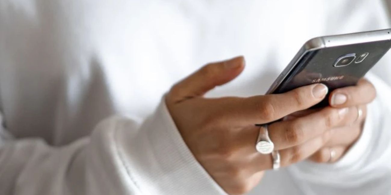 Person looking at their phone - Complaint management Tenant Satisfaction Measures