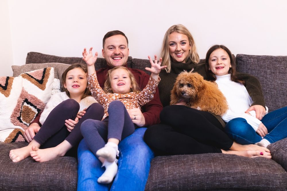 Platform Cunstomer Annual Report - Happy family sat on a sofa 