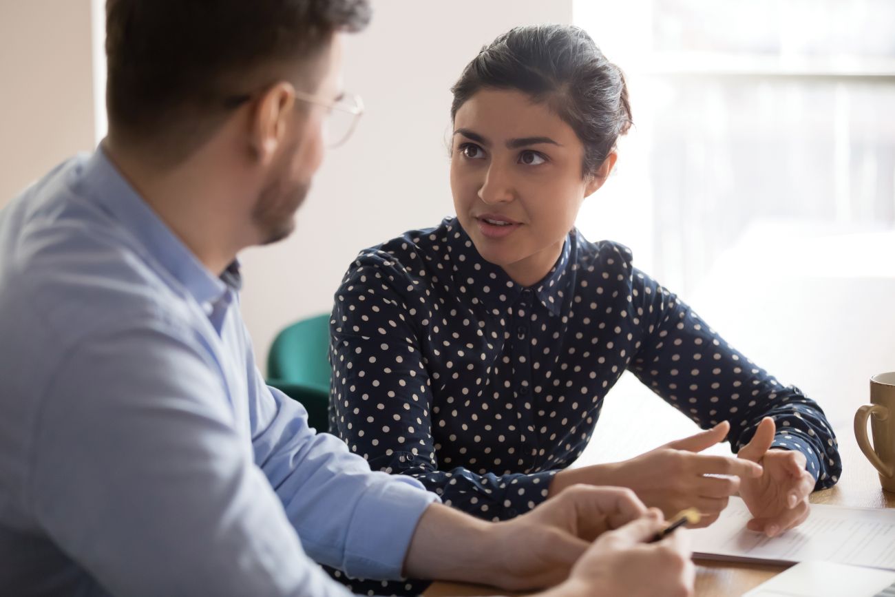 Asian Woman giving a man advice on Universal Credit
