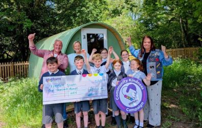 Children and staff at the school with a giant cheque