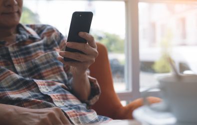 A man using a phone to access our customer voice