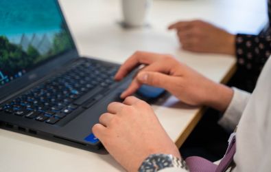 A young person on a laptop