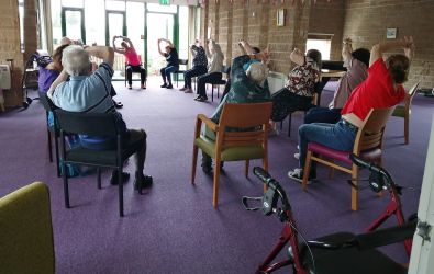 Residents taking part in seated exercises