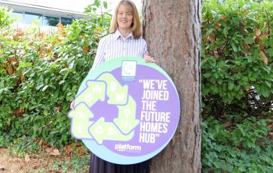 Our CEO holding a Future Homes Hub logo