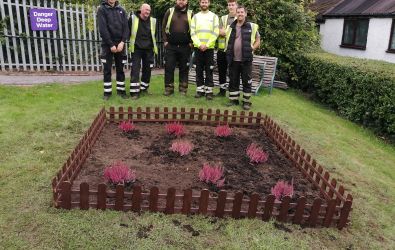 Colleagues planting wildflowers