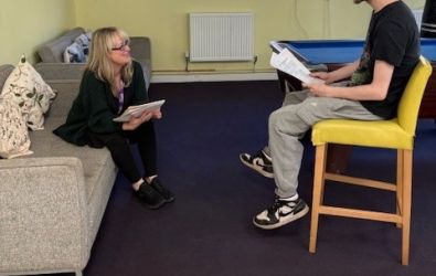A youth worker talking to a young person at the Foyer