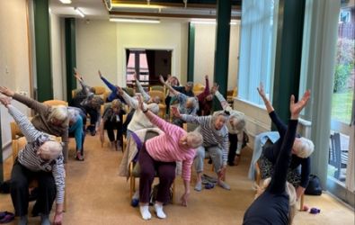 Residents doing seated yoga