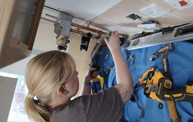 Caitlin fixing a boiler